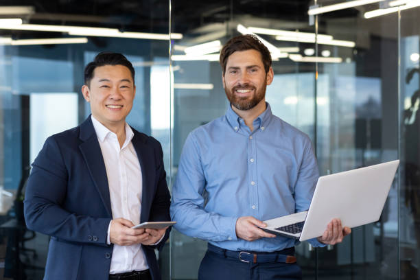 istock Confident businessmen collaborating in modern office environment, teamwork in corporate setting 2148456974