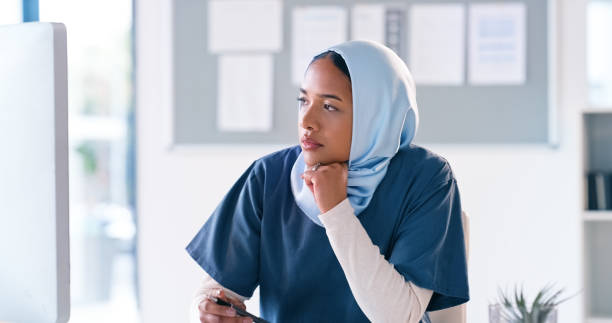 istock Computer, thinking and nurse with solution, ideas and study of moral, ethics or religion in medical research. Muslim woman in medicine, reading and analysis of clinic report for inclusive healthcare 2148457171