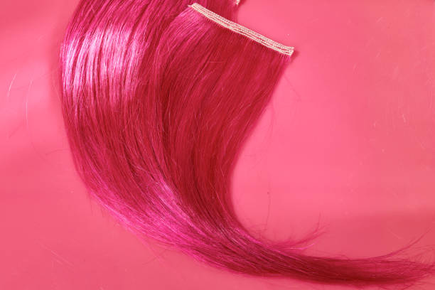 Hot pink hair swatch on pink background with copy space