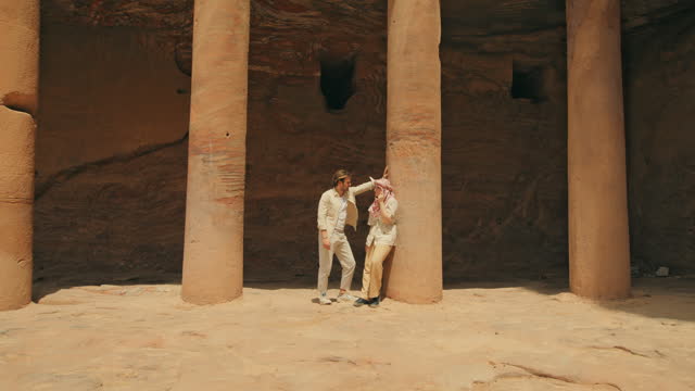 Couple leaning against Petra's pillars