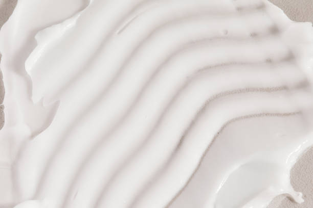 istock Macro shot of face cream moisturiser textured swatch on concrete background. 2148461314