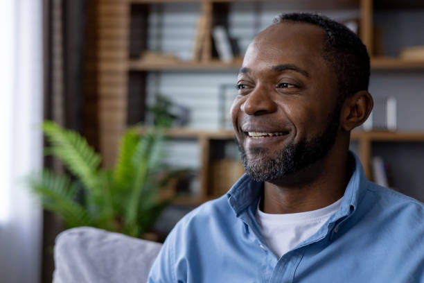 Portrait of smiling african american man enjoying relaxation indoors