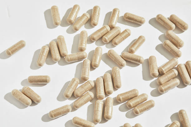 istock CLose up shot of neutral herbal caprules on white background with copy space 2148462496