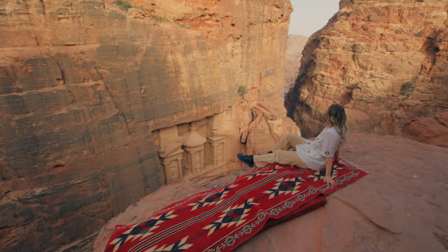 Woman on a red carpet looking at Petra