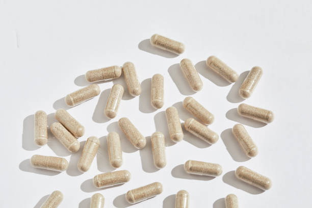 istock CLose up shot of neutral herbal caprules on white background with copy space 2148462590