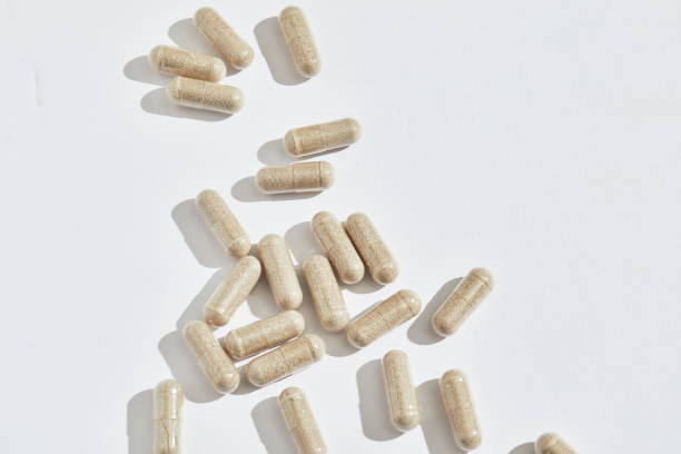 istock CLose up shot of neutral herbal caprules on white background with copy space 2148462591