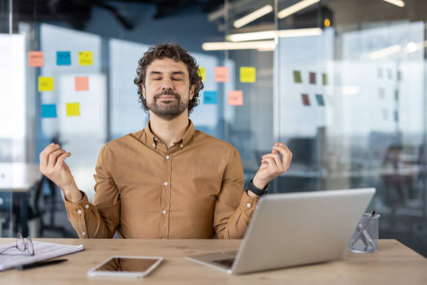 istock Professional meditating at a modern office desk 2148462804