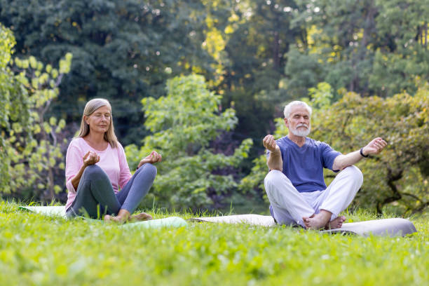 istock Senior couple in serene meditation pose outdoors practicing mindfulness together 2148463504