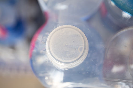 Bottled water cap on a stack of bottled water packs