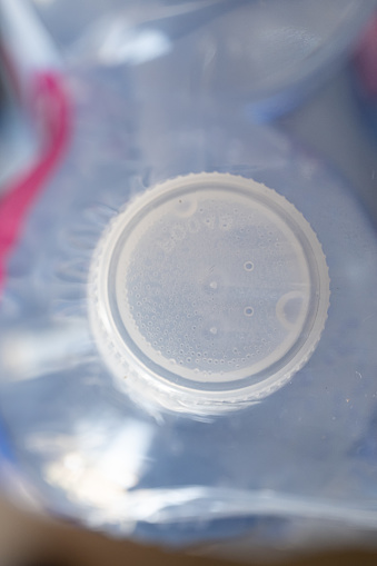 Bottled water cap on a stack of bottled water packs