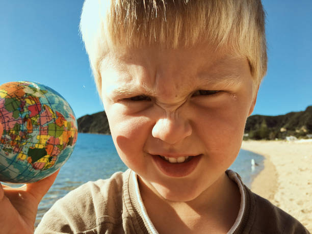 Very upset caucasian little boy looking at the camera
