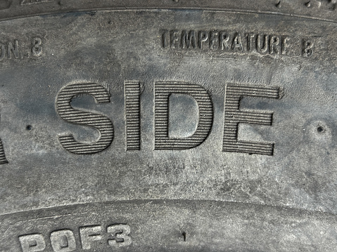 Closeup of text SIDE on a old tyre with texture and patterns.