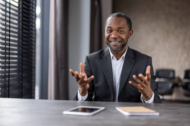 istock A man in a suit is sitting at a desk with a tablet and a notebook 2148465793