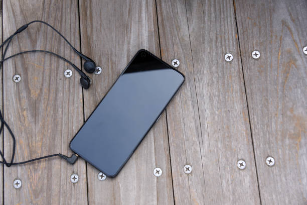 istock Smartphone playing music on a wooden bench 2148466499