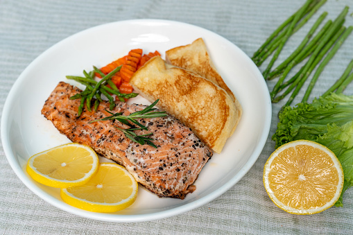 Salmon Steak with Butter Toast Ready to eat on a wooden table.