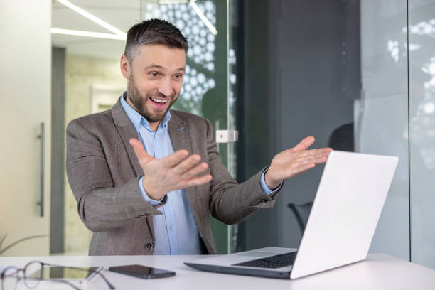 istock Businessman on a video call at a modern office desk 2148468882