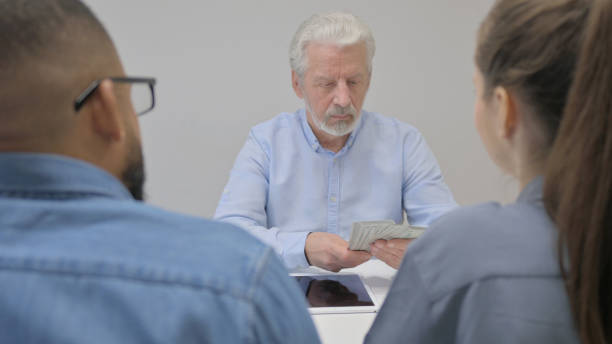 istock Old Businessman Shaking Hand after Giving Money 2148469849