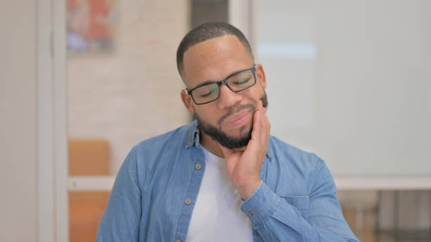 istock African Man with Toothache in Office 2148470030