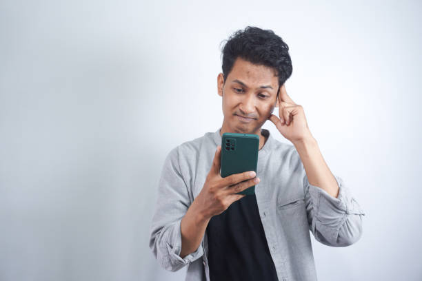 istock Man look confused at mobile phone, reading strange message on cellphone screen, receive bad news on smartphone social 2148470236