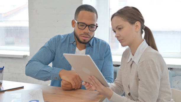 istock Business People Discussing Project on Tablet 2148470886