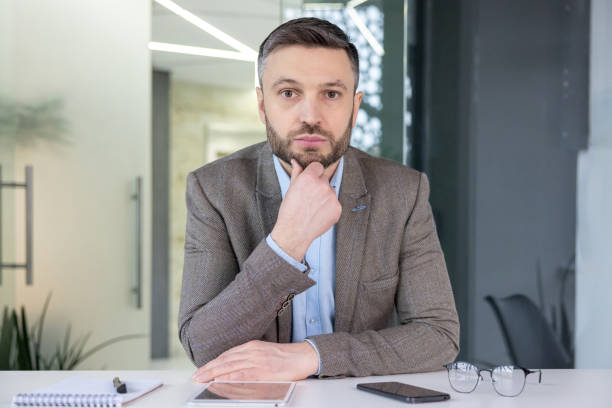 istock Professional man on a video call at a modern office 2148471039