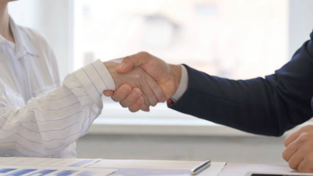istock Close up of Business People Shaking Hand at Work 2148471338