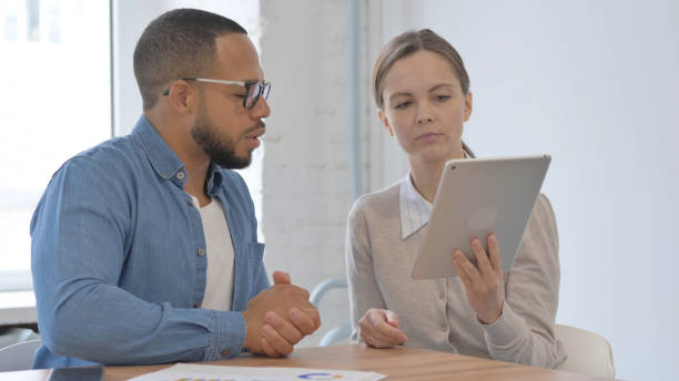 istock Multi Ethnic Casual People Working on Tablet in Office 2148471483