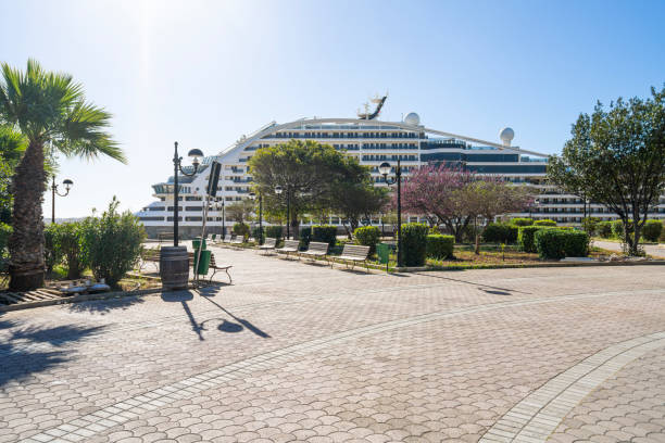 Valletta, Malta, April 03, 2024.  a large cruise ship glimpsed in the port from a garden in the city centre