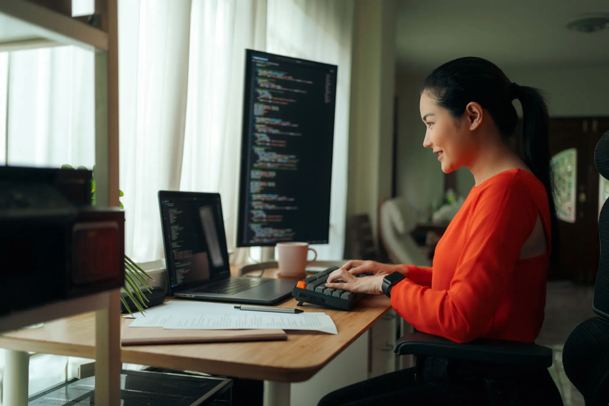 Woman Programmer Engaged in Coding at Desk