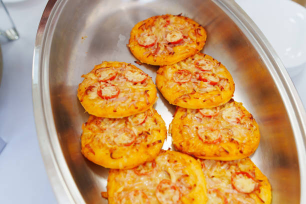 Heated tray with mini pizzas. Banquet food delivery. Catering for the holiday.