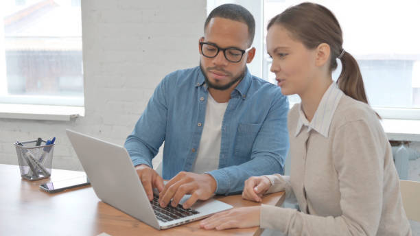 istock Mixed Race People Working on Laptop Together 2148471860