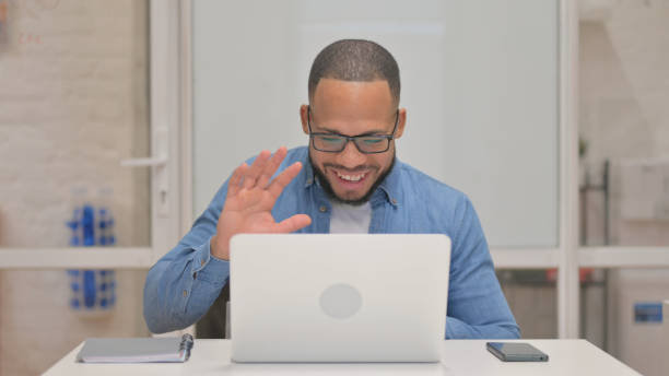 istock Mixed Race Man Doing Video Chat on Laptop 2148472510