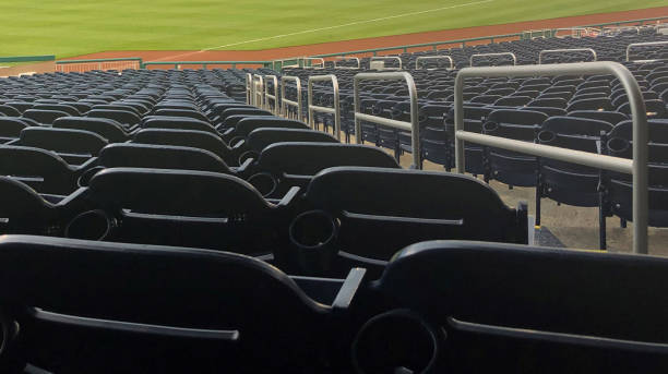 Stadium Seats View of stadium seats. View from above down toward field. Baseball field. Railings and stairs on the right. baseball stadium chairs stock pictures, royalty-free photos & images