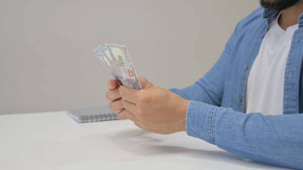 istock Close up of Hands Counting Money 2148472677