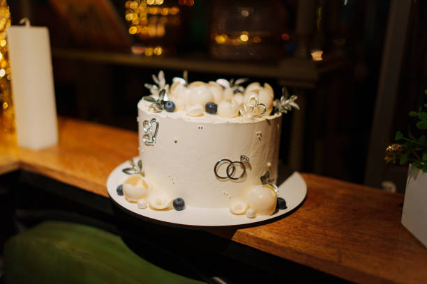 istock White wedding cake decorated with chocolate flowers and blueberries 2148472740
