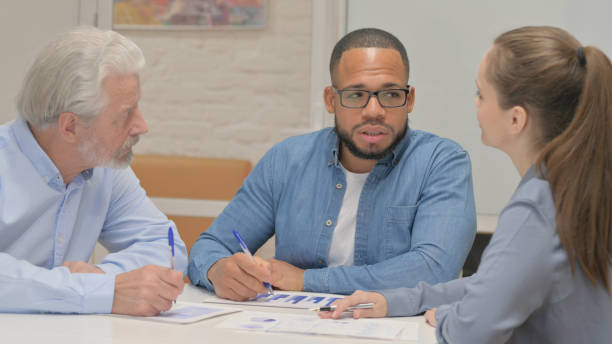 istock Hispanic Man Talking with Business People 2148472982