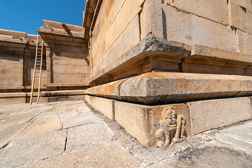 A lion carving at the base of an ancient stone temple in Shravanabelagola