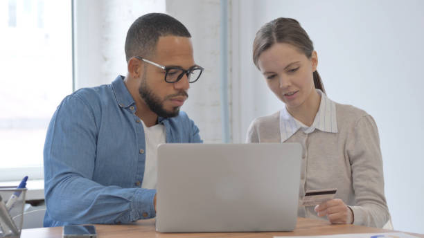 istock Multi Ethnic Casual People Enjoying Online Shopping in Office 2148474089