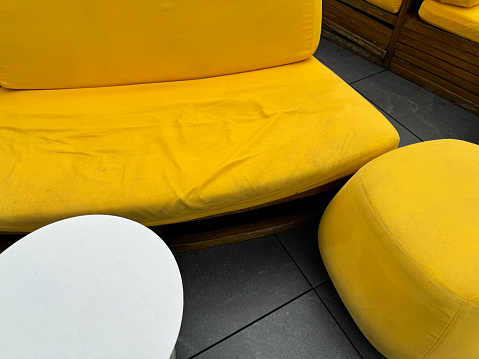 Stock photo showing close-up, elevated view of garden furniture that needs to be washed due to mould.