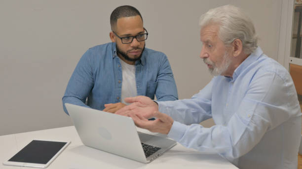 istock Angry Old Man Talking with Male Worker in Office 2148474267
