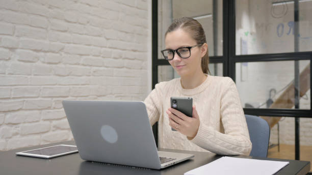 istock Creative Woman Working on Laptop and Smartphone 2148474715