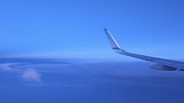 Looking through window aircraft during Vietnam domestic flight in wing with a nice blue sky cloud.