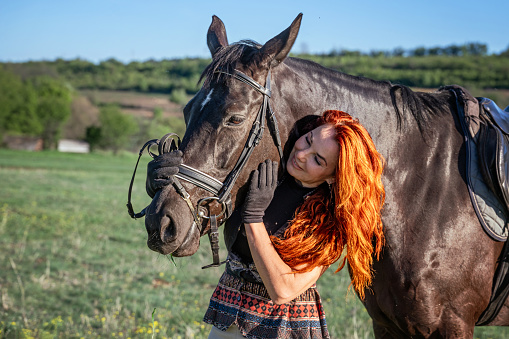 Mature female horse rider with her horse