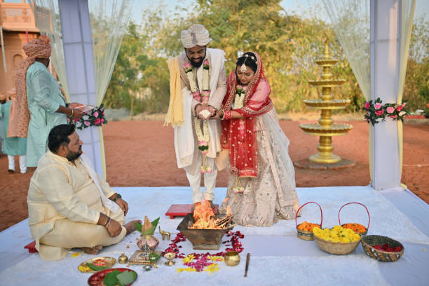 istock Indian bride and groom putting puffed rice into the fire (Havan) during the wedding ceremony 2148476715