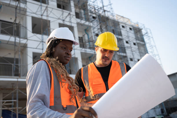 istock Worker engineer African woman working with caucasian worker at construction site 2148476795