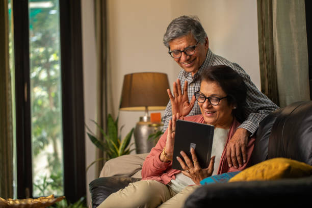 istock Elderly happy couple talking on video call at home 2148476907