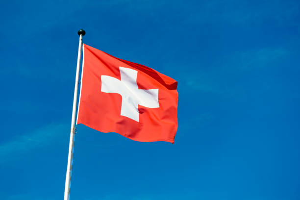 istock Switzerland national flag waving in the wind 2148477054