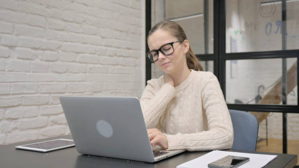istock Creative Woman having Neck Pain at Work 2148477087