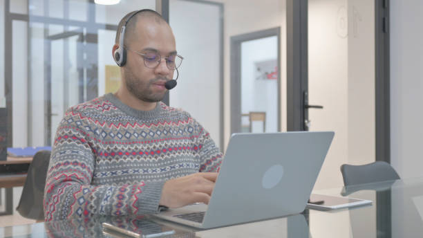 istock Call Center Employee with Headset Working in Office 2148477605