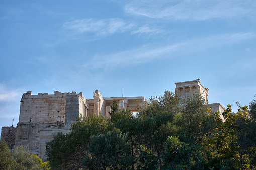 General view of the Parthenon and the ancient Acropolis of Athens Greece from a low area between trees